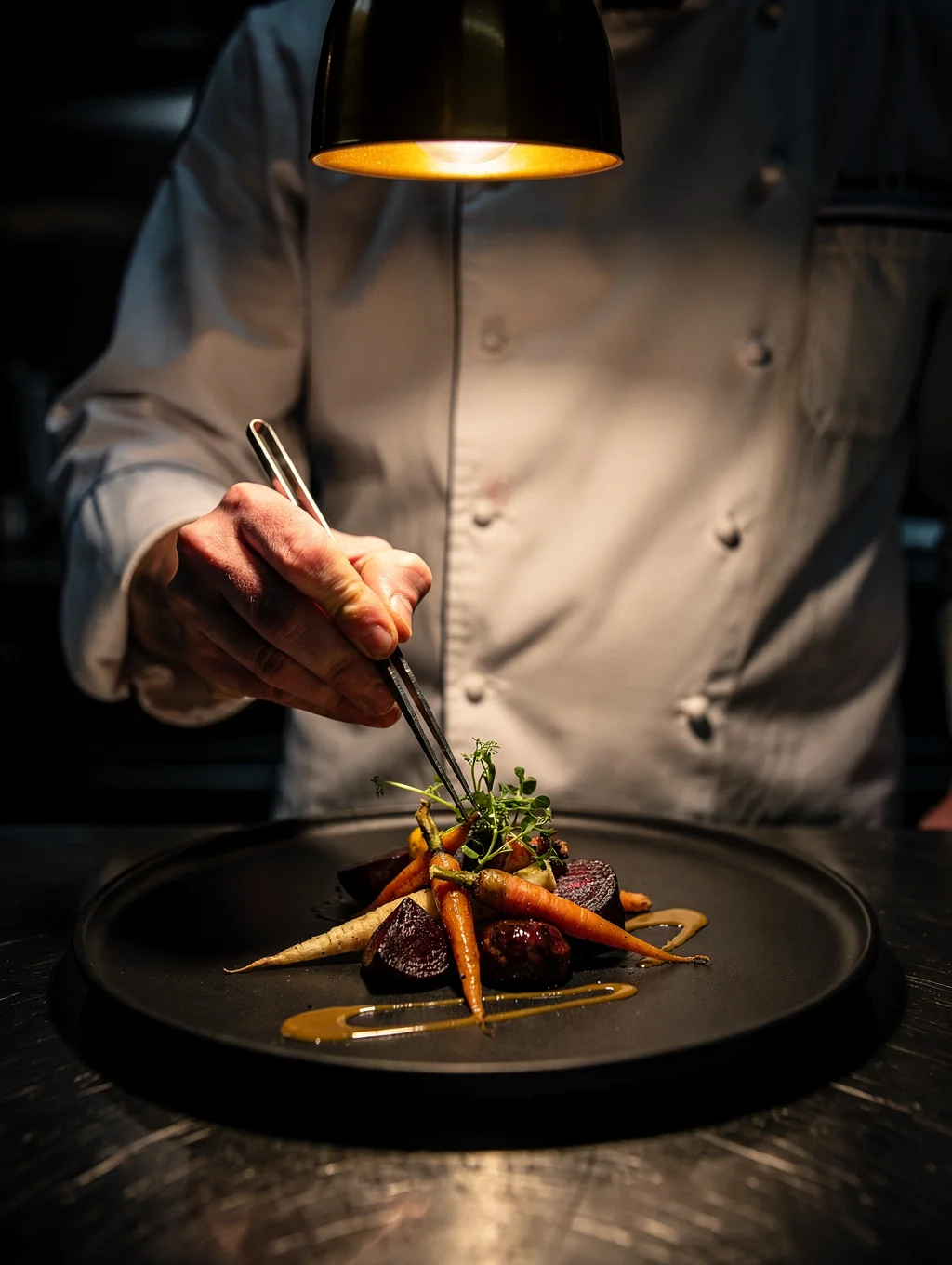 Chef preparing fresh seasonal ingredients in our open kitchen
