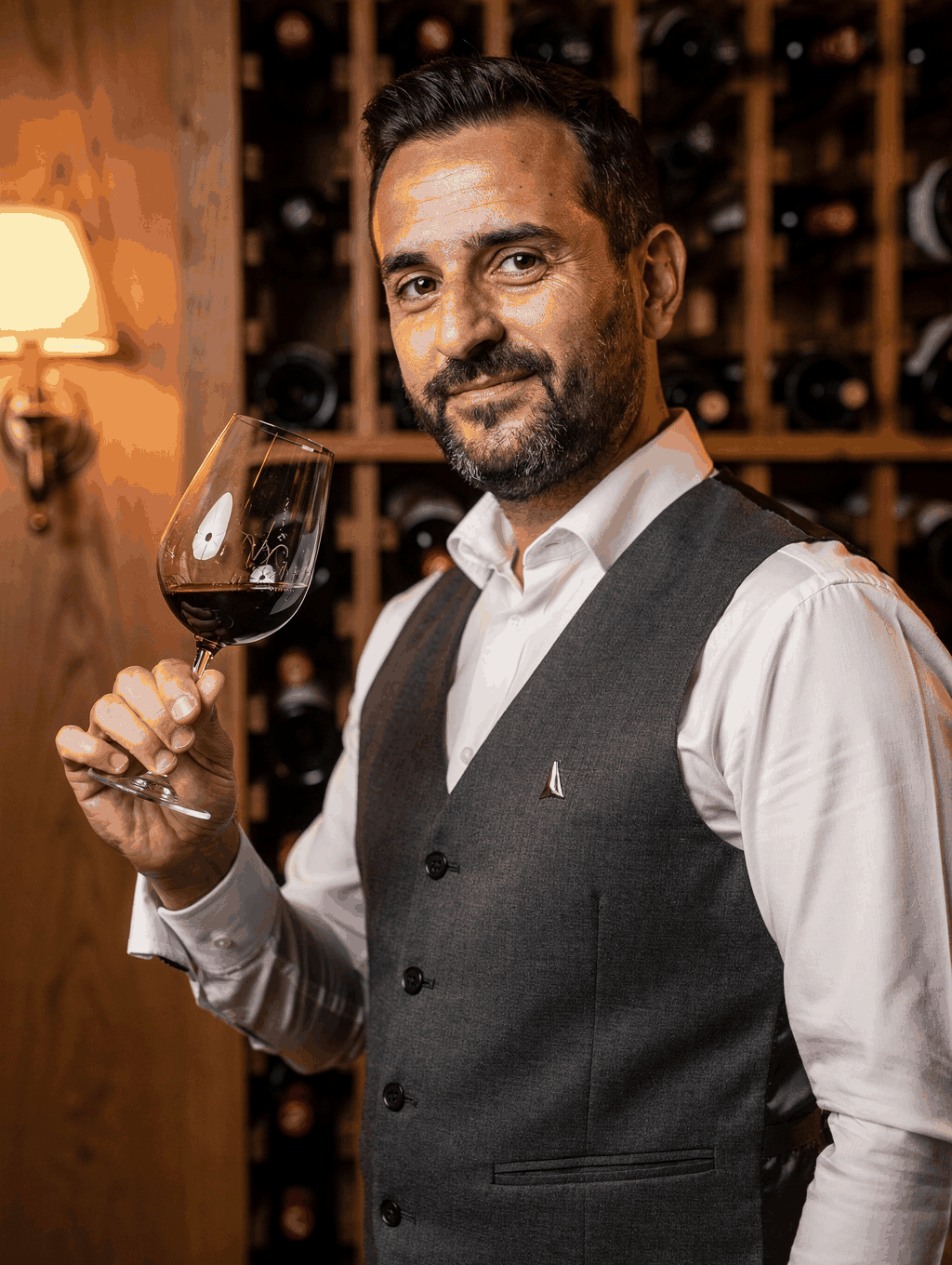 Sommelier Giovanni Conti pouring vintage Barolo in cellar